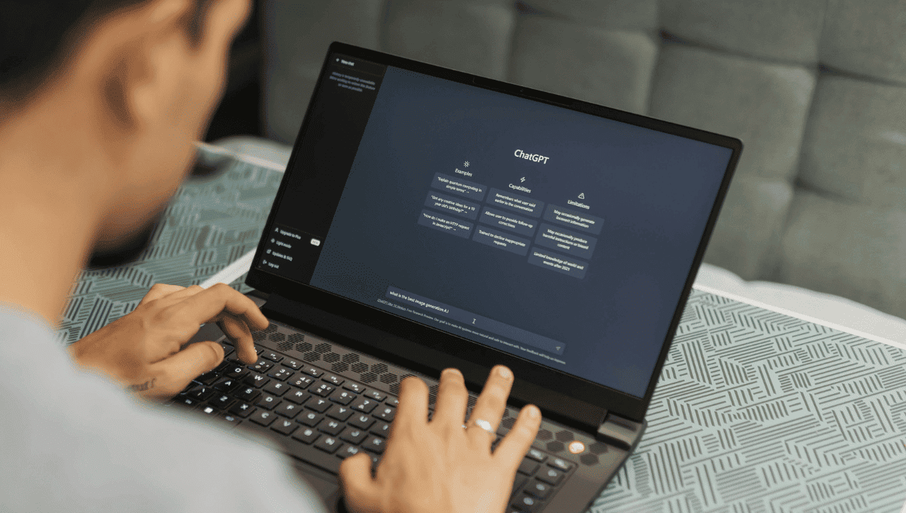 Person using a laptop displaying an AI chatbot interface