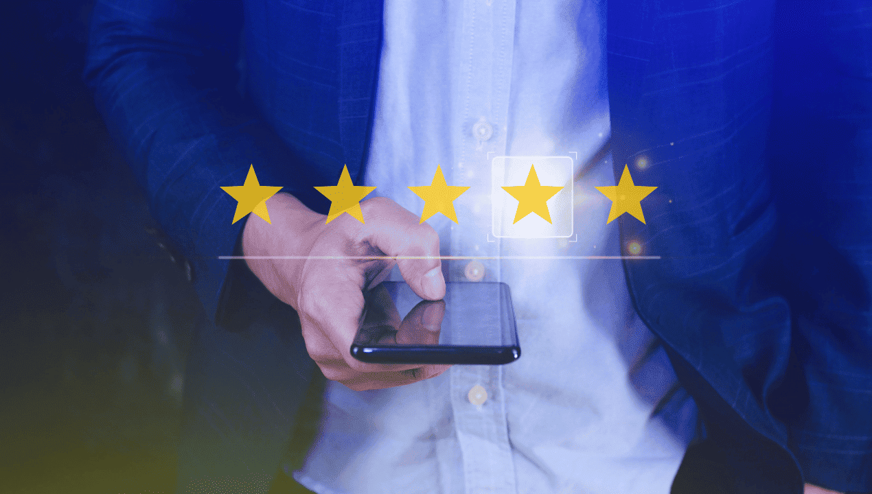 Person holding a phone beneath a row of five yellow review stars