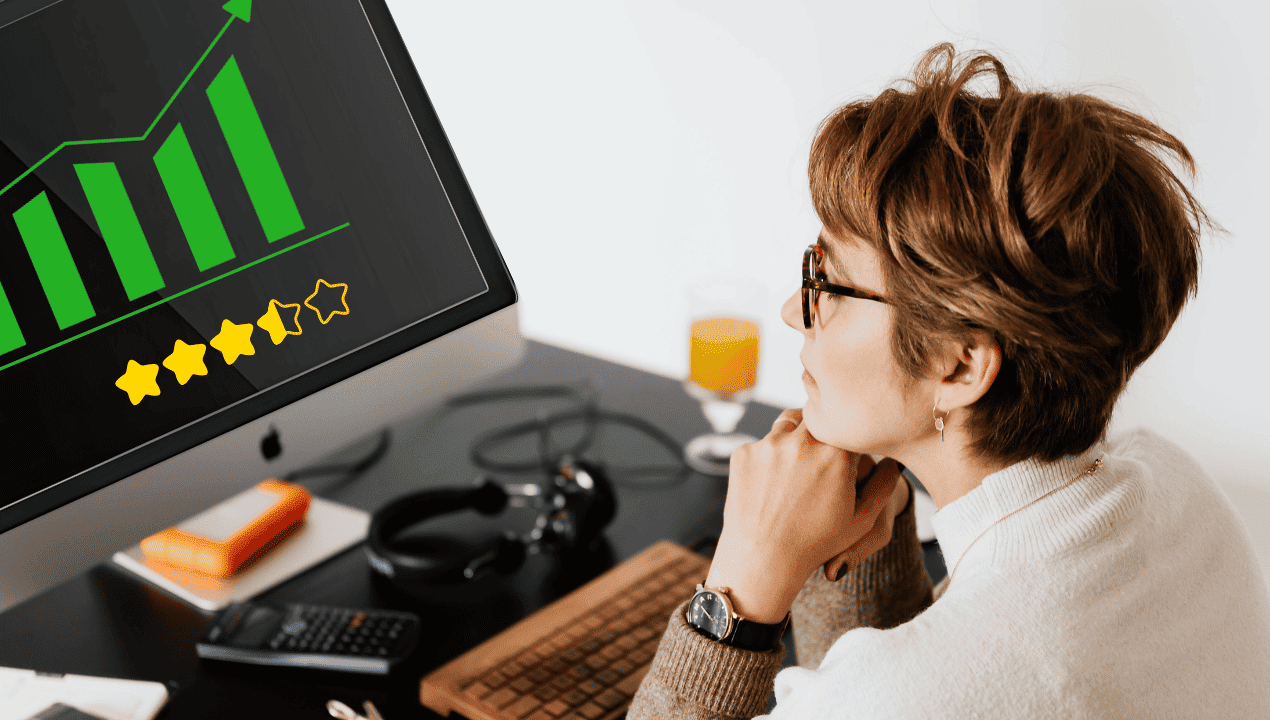 Person looking at a computer dashboard with rising green bars and review stars